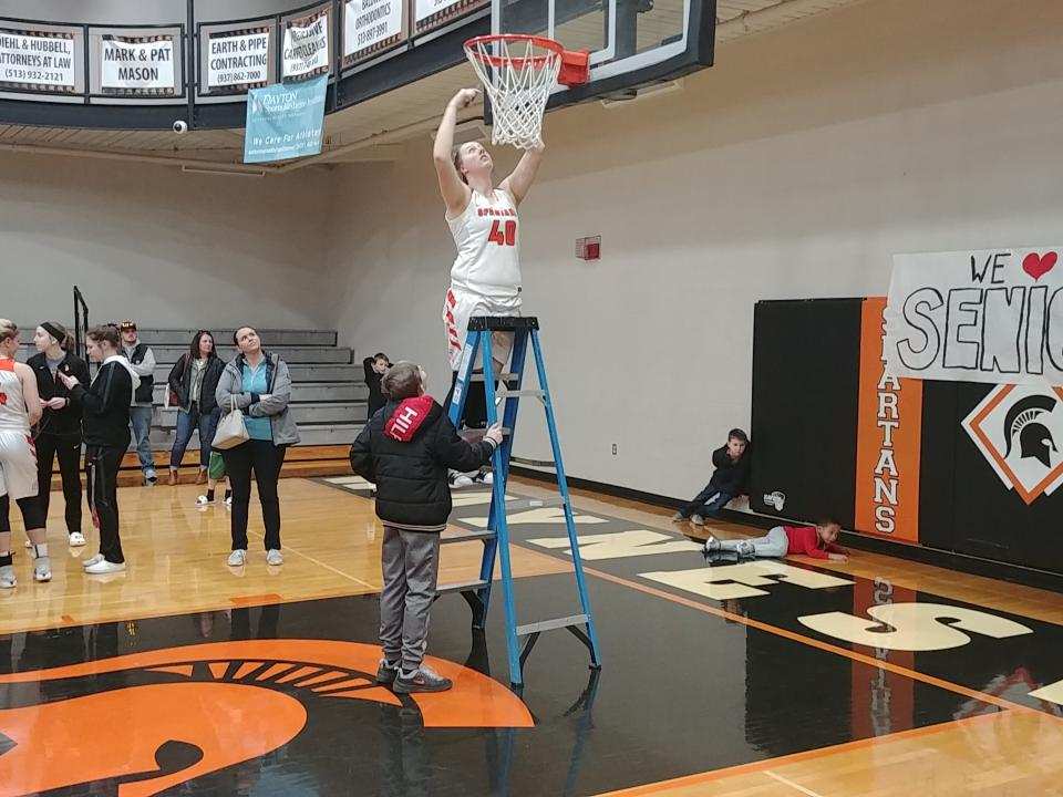 Cutting down a basketball net 