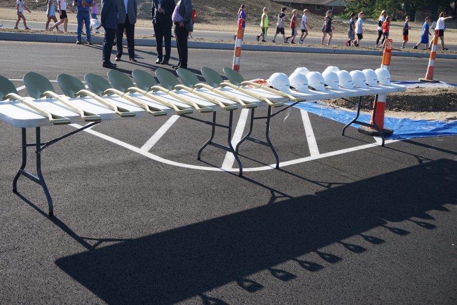 table with hard hats and shovels