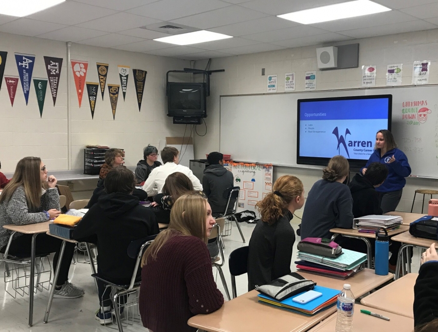 girl speaking to a room full of students