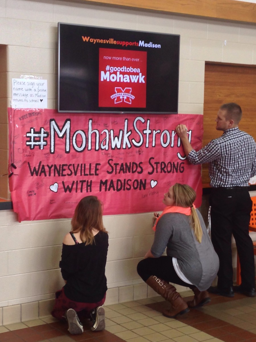 image of people writing on a banner