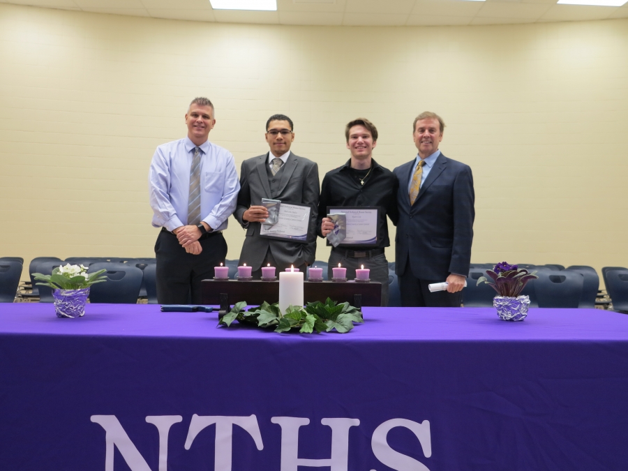 four people of which two are holding awards