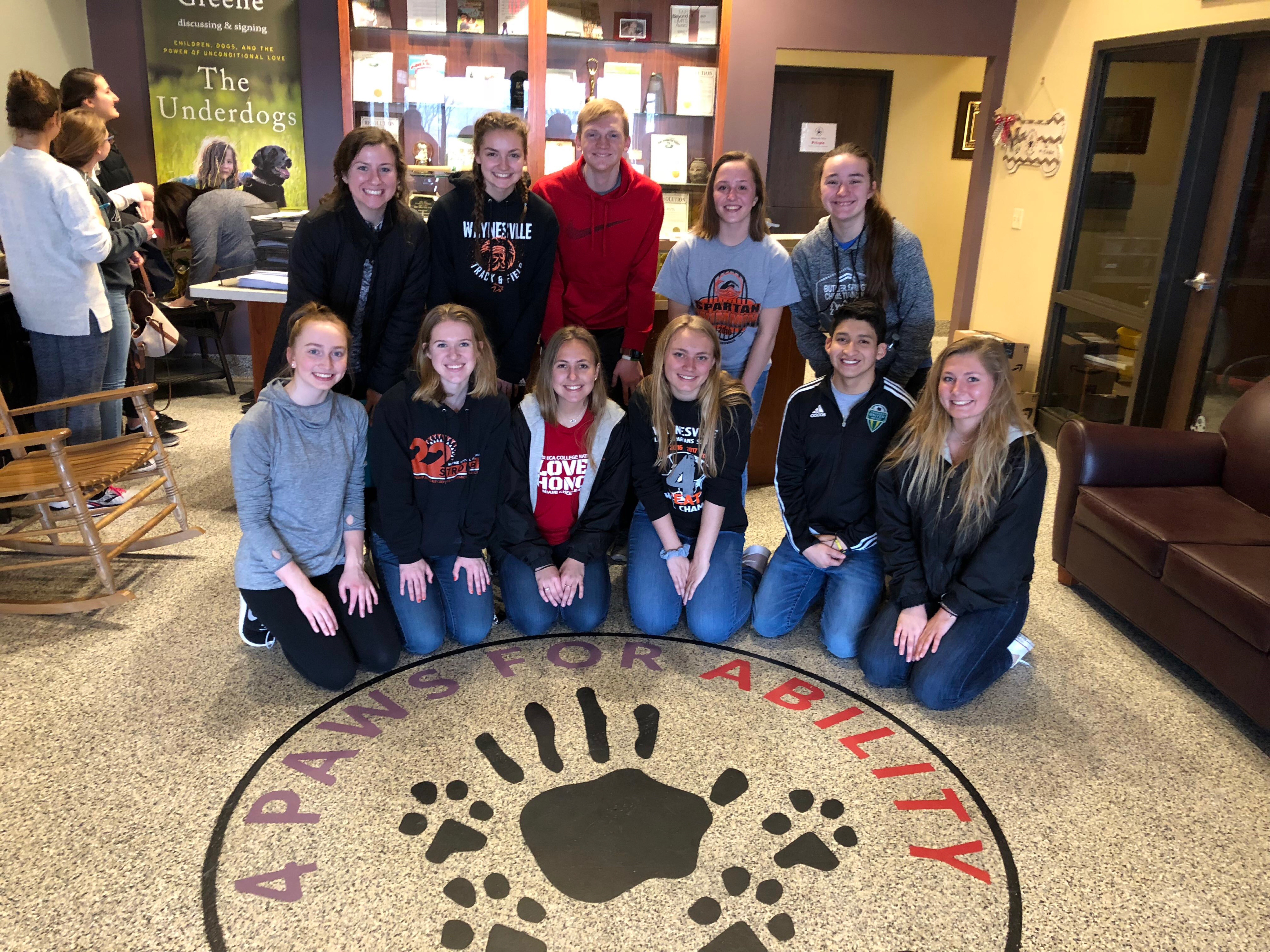 group of young people with a paw on the floor