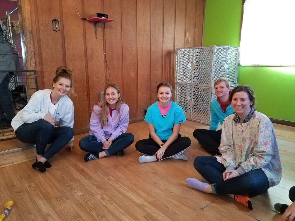 young people sitting on a floor