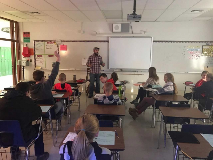 teacher in front of a projector screen