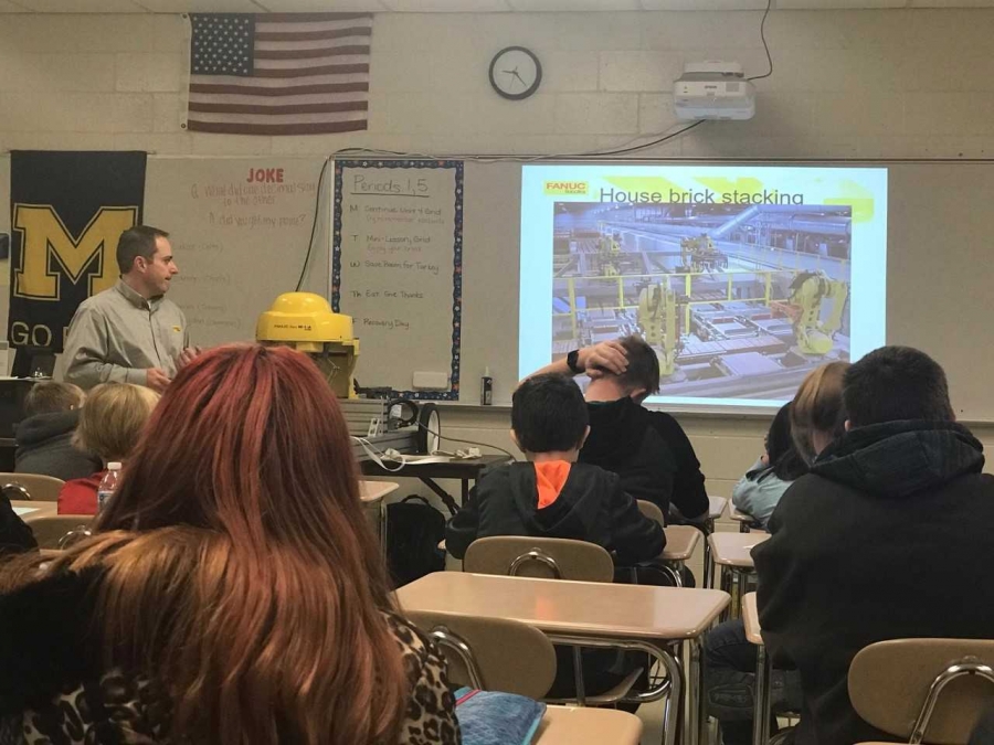 teacher in front of a projector screen