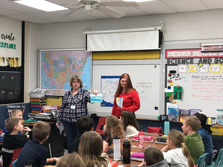 two ladies talking to a young group of students