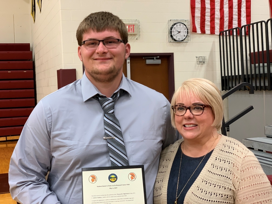 young man and a woman with a certificate