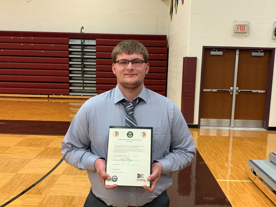 young man holding a certificate