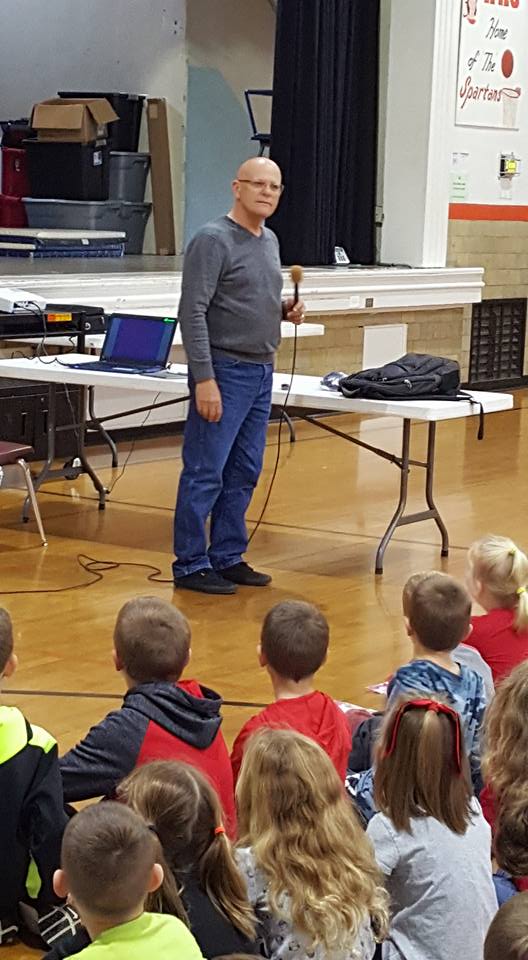 man talking to a group of students