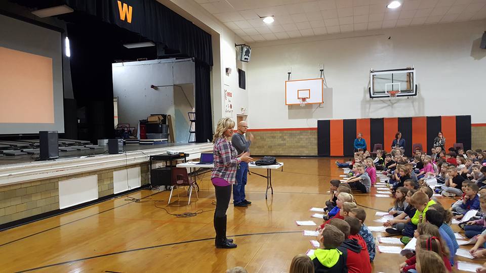 man talking to a group of students