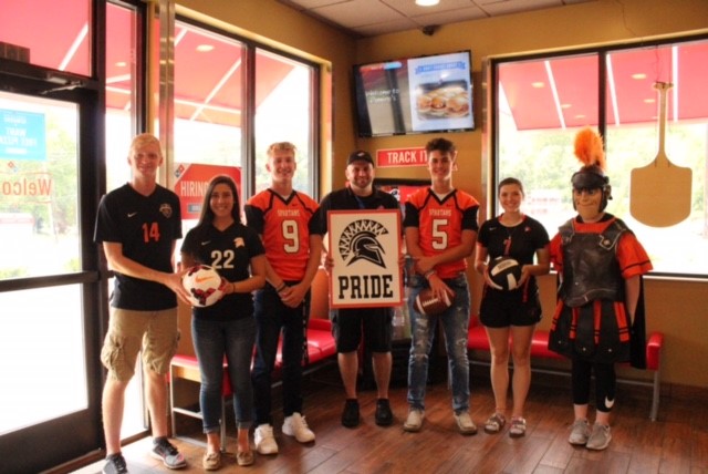 people wearing jerseys and holding sign