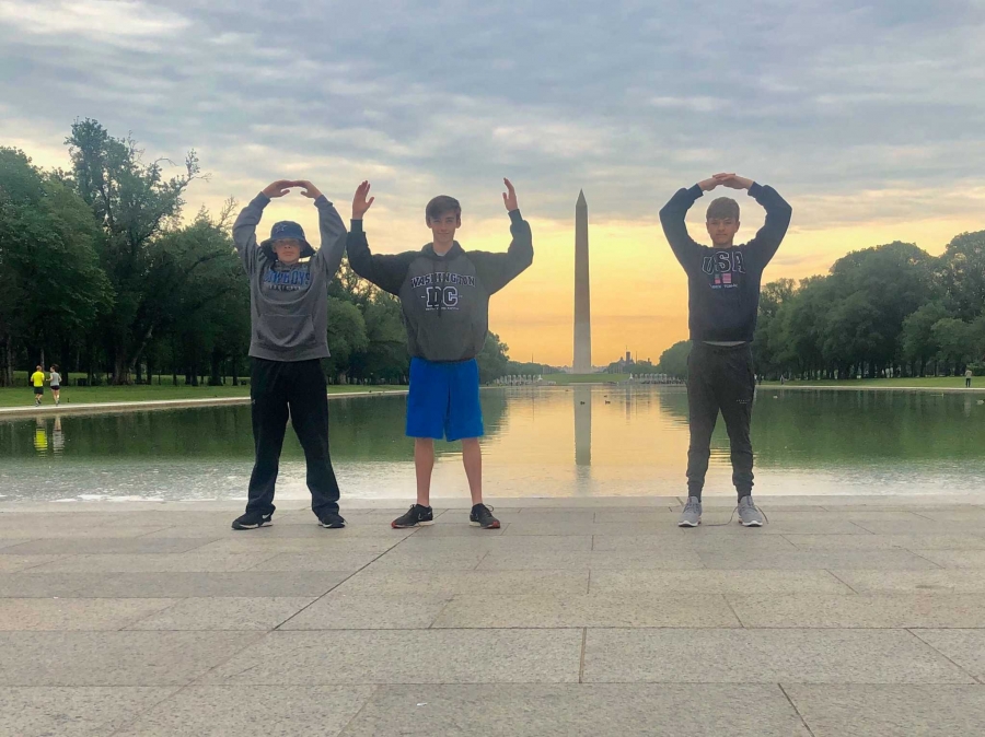 student forming Ohio with their arms