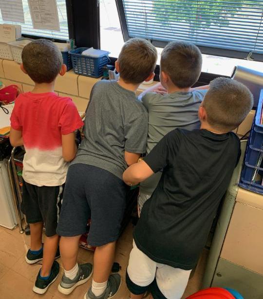 children looking out a window