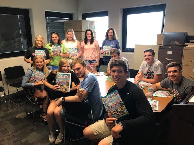 image of people holding books