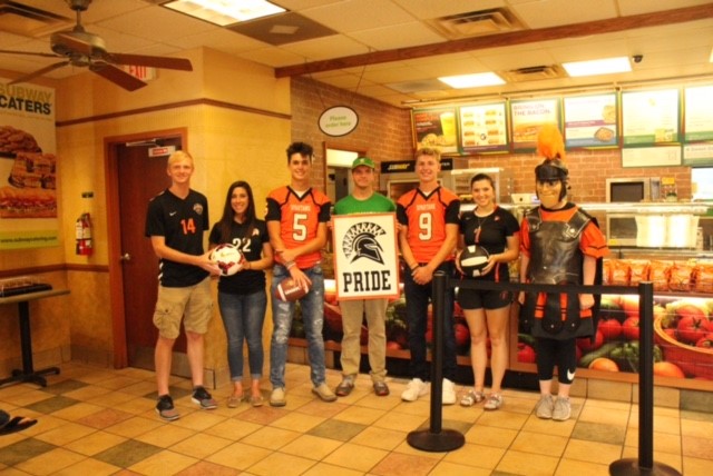 people wearing jerseys and holding sign