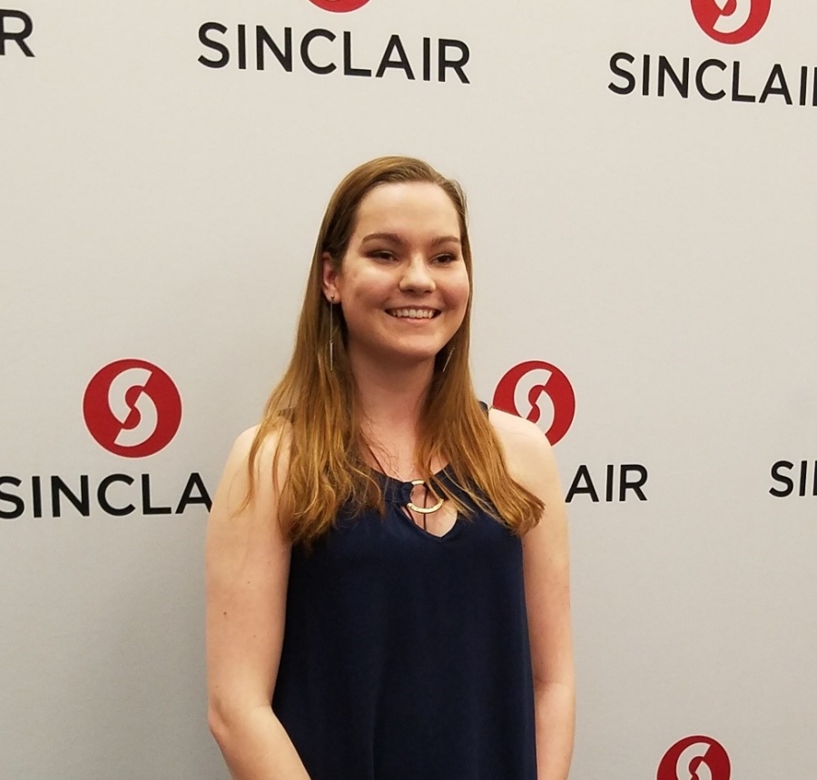 image of a girl in front of a sign board