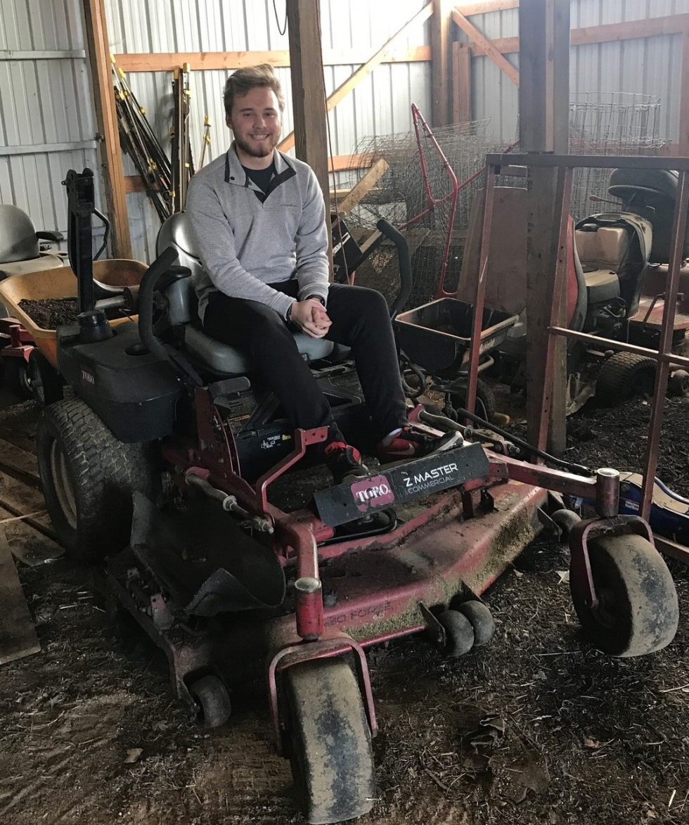 boy on a lawn mower