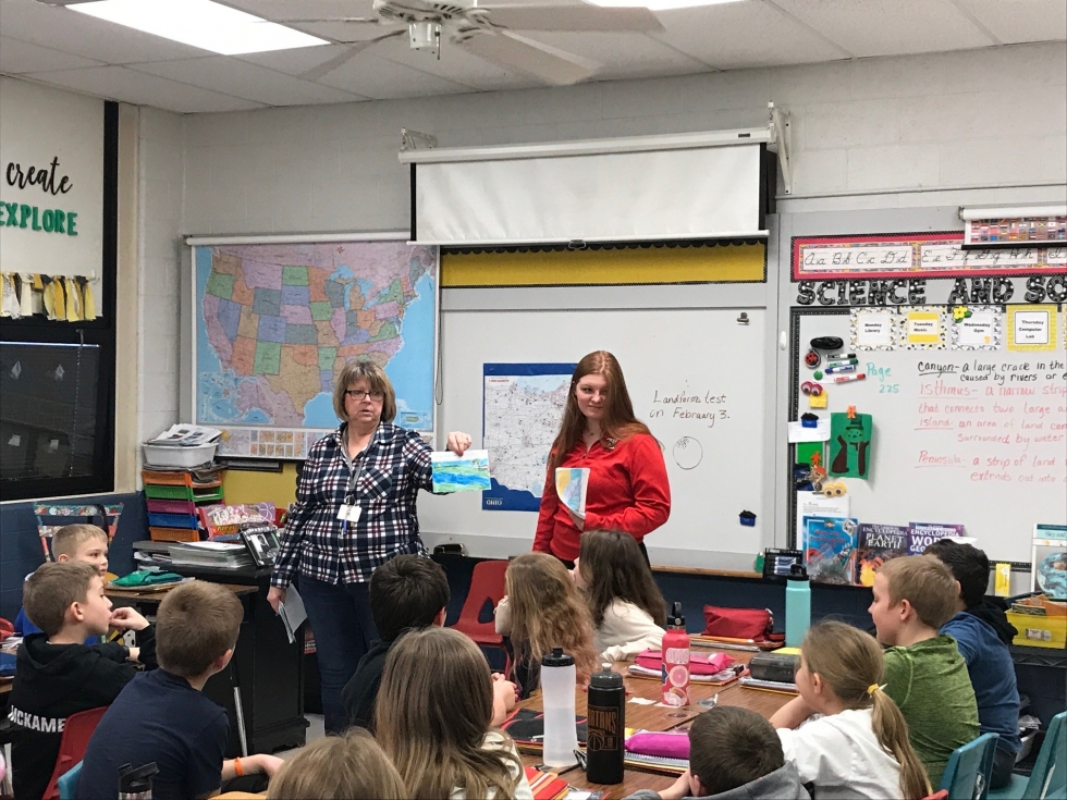 two ladies in front of a class of students