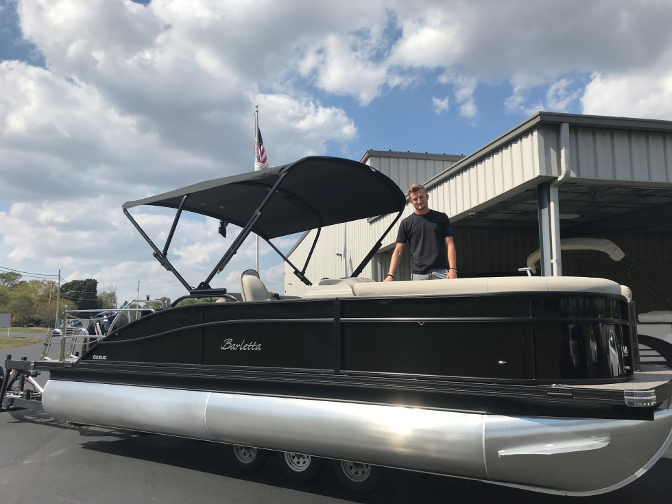 boy on a pontoon boat